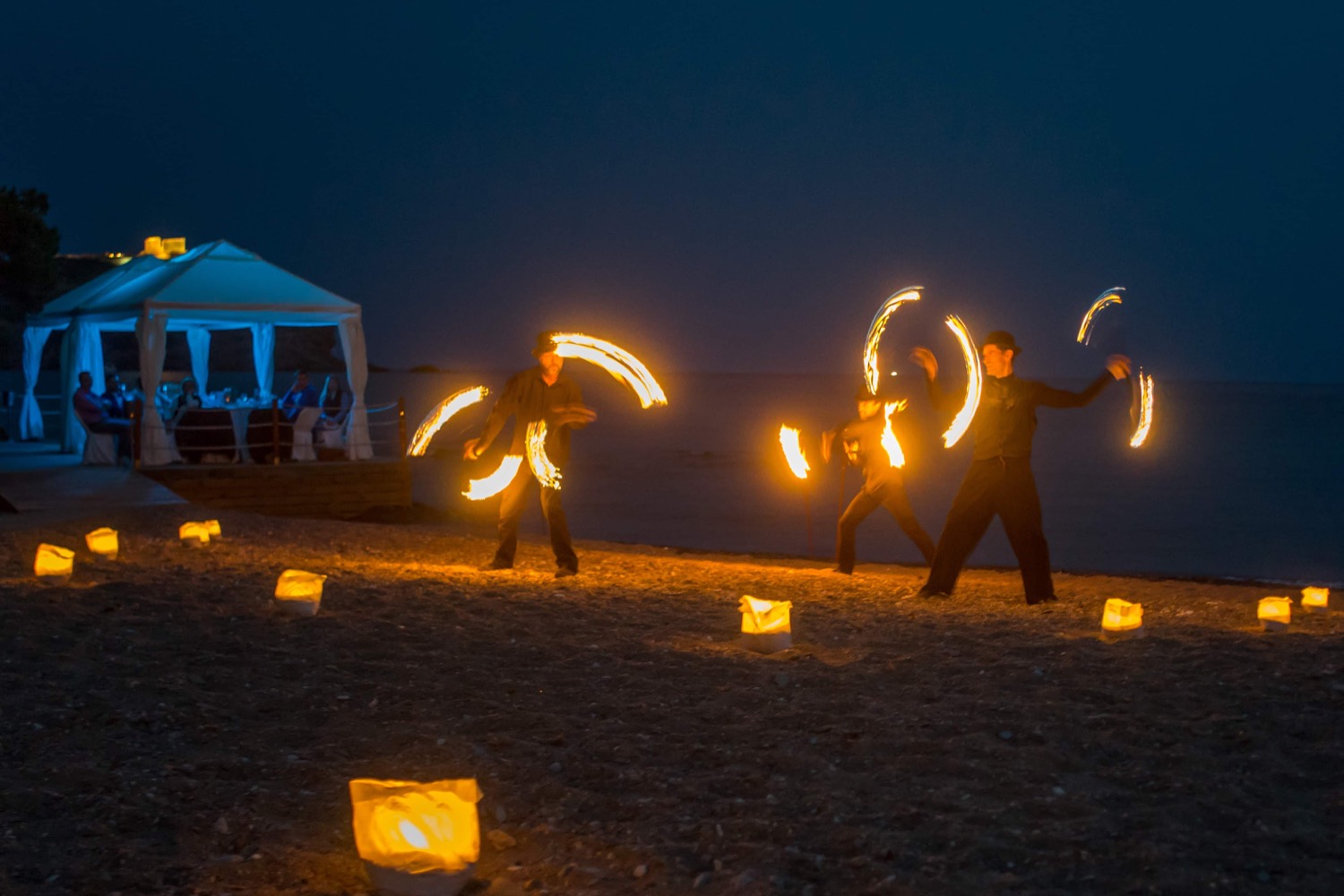 Outdoor evening event with fire performers